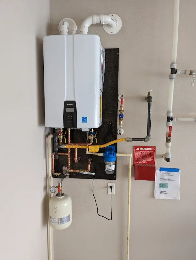 Professional plumber installing copper piping in a Cranbury home